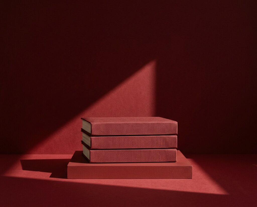 Three oxblood clothbound books
