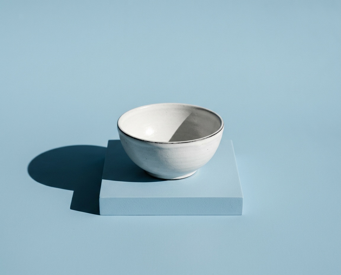 Empty white bowl on powder blue