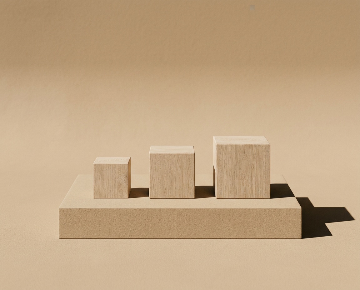 Three graduated oak blocks on sand