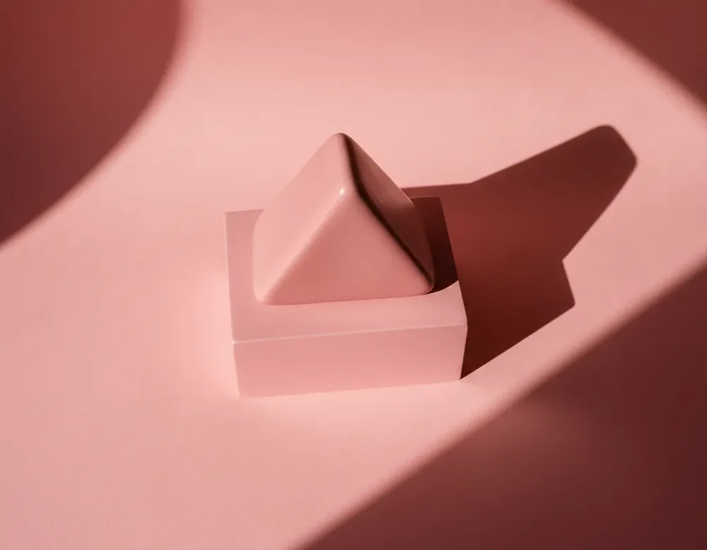 A pink ceramic triangle from a high angle
